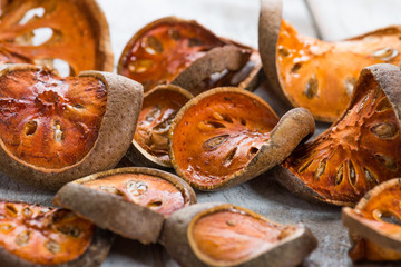 Dry Bael fruit - Slices of dry Bael fruit on the wooden table