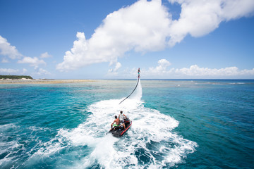 Obraz premium A Flyboard rider stands on a board