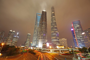 Fototapeta na wymiar the light trails on the modern building background in shanghai china