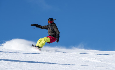 Fototapeta na wymiar Woman Snowboarding Carving a Snowboard