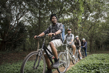Fototapeta na wymiar Group of friends ride mountain bike in the forest together