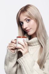 Blonde woman drinking a cap of tea