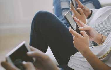 Friends using smartphone together at home