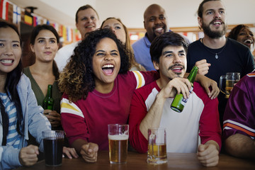 Frieds cheering sport at bar together