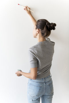 Artist Woman Painting The Wall