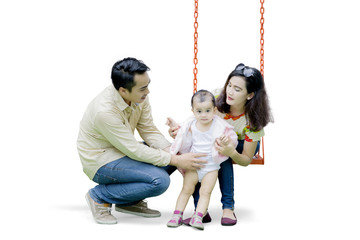 Asian family playing with swing