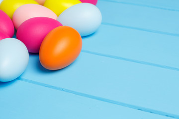Easter eggs on wooden background with space