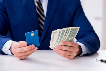 Businessman holding dollar money and credit card