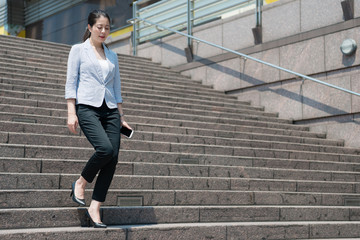 Fototapeta na wymiar business woman walking down on the stair