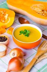 Pumpkin soup served on the table in bowl