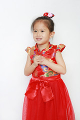 Happy little Asian child girl wearing red cheongsam with greeting gesture celebration for Chinese New Year isolated on white background.