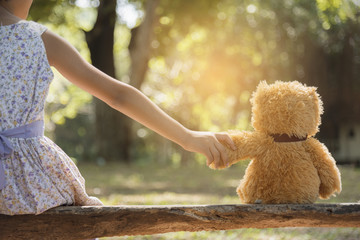 teddy bear is a best friend for all little cute girl. Child autism can be more happy and fun when they're play in family. Feel love and care. Family Friendship Concept.