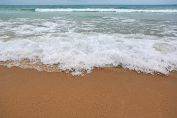 Fototapeta na wymiar Background of sea wave and sand beach.