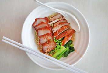 Top view Egg noodle with roasted duck and pork, Chinese food.
