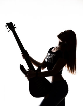 silhouette of rock woman playing on electric guitar on a white background.