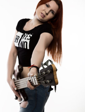 rock woman playing on electric guitar on a white background.
