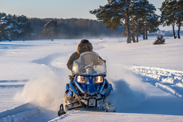 Man on snowmobile. Recreation concept on nature in winter holidays. Winter sports. driver of a...