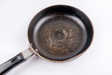 An old cast iron frying pan isolated on white