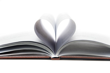 Close up heart shape from paper book on white background