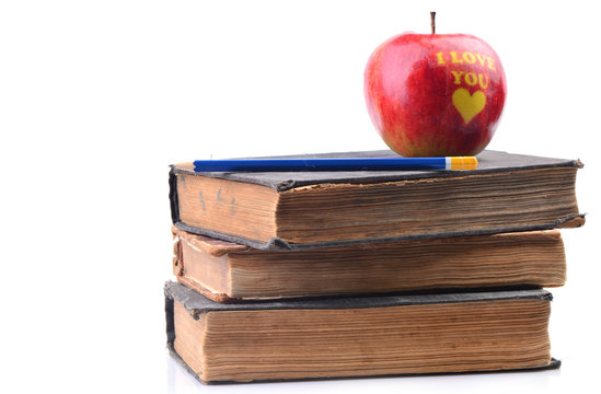 Books and an apple on a white background