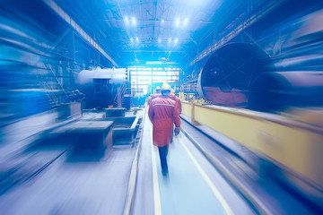 technological background workers in motion in the factory blurred