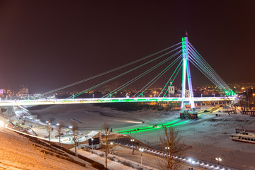 Fototapeta na wymiar Bridge of lovers with night illumination. The city of Tyumen. Russia