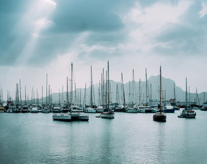 Sailboats and pleasure boats in the porto grande bay of the historic city Mindelo. Clodscape with Sunrays