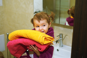 Naklejka premium Cute kids in bathrobes in the bathroom. Cheerful brother and sister after water treatments