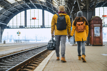 couple at railway station wiring for train