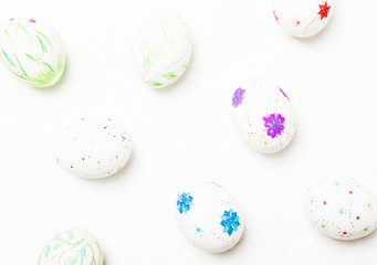 White easter eggs with a hand-drawn pencil pattern, white background, top view