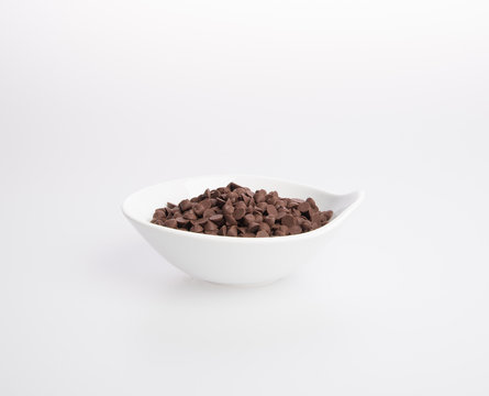 Chocolate chip morsels spread on a background.