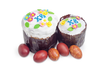 Two Easter cakes and Easter eggs on a white background