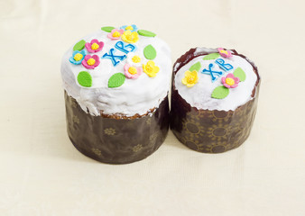 Two Easter cakes different sizes on the tablecloth