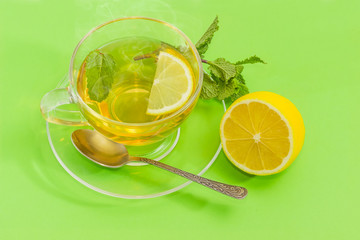 Tea with mint and lemon in glass cup