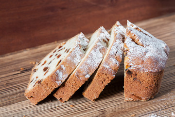 Homemade traditional chopped cupcake with raisins on the wooden background. Closeup, selective focus