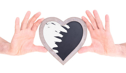 Adult holding heart shaped chalkboard