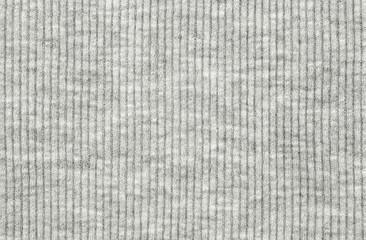 Real white-grey knitted fabric made of synthetic fibres textured background.