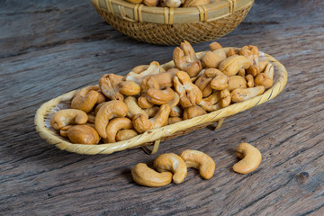 Cashew nuts in basket isolated on Wood background