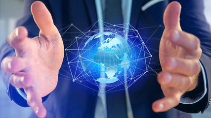 Businessman holding a Connected network over a earth globe concept on a futuristic interface - 3d...
