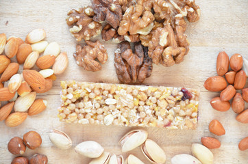 Granola bars with nuts and dried fruits on wooden background- snack for healthy still live