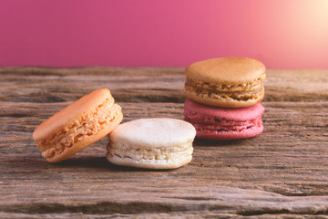 Different types color of macaroons on Old grunge wooden background
