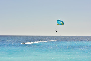 Recreation at sea. Tourist travel. Coast of the Mediterranean. Flying in a water parachute.