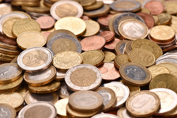 Euro coins scattered on the table. Good earnings. Financial flows.