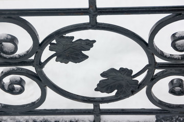 Artistic forging. Part of the forged fence. Leaves from metal.