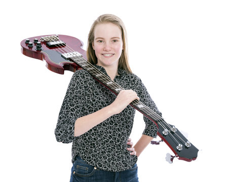 blond pretty teen girl and red bass guitar against white background in studio