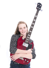 Fototapeta premium blond pretty teen girl and red bass guitar against white background in studio