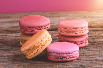 Different types color of macaroons on Old grunge wooden background