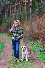Young girl with a dog in the wood