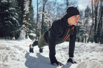 Fototapeta na wymiar Man Sportsman Taking Break From Running in Extreme Snow Conditions