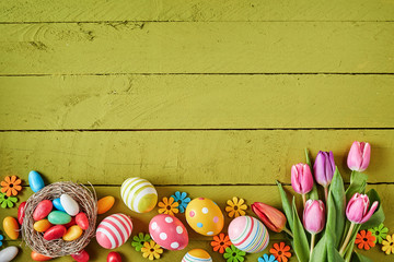Colorful Easter border on green wood